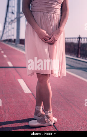 Nice professional female dancer standing in the primary pose Stock Photo