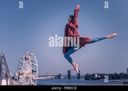 Professional young female dancer doing graceful jump Stock Photo