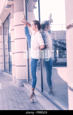 Positive beautiful woman dancing on the street Stock Photo