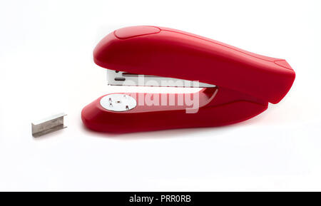 Red stapler with metal staples close up isolated on white background Stock Photo