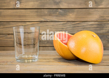 Juicy grapefruit close up view on wooden background Stock Photo