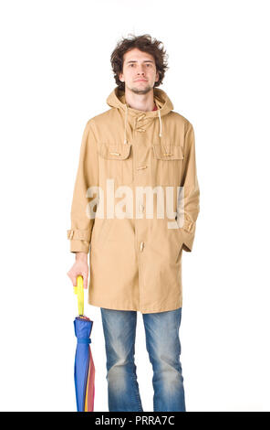 Man wearing in coat keeping closing umbrella Stock Photo