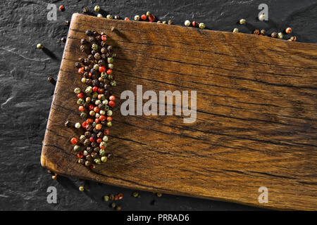 Top view of colour pepper on wooden desk and black table background Stock Photo