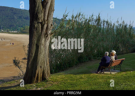 Three senior ladies sitting on a bench in the Trengandin beach park, Noja, Cantabria, Spain, Europe Stock Photo