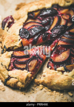 Plum galetta sweet cake on baking paper, selective focus. close-up. Seasonal Fall or Autumn dessert Stock Photo