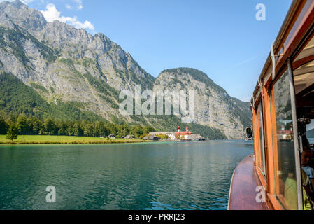 View from a passenger boat on Lake Königsee, in the back boat landing stage St. Bartholomä and Watzmann, mountain landscape Stock Photo