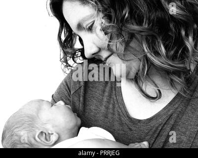 Black and white portrait of young woman and sleeping baby Stock Photo