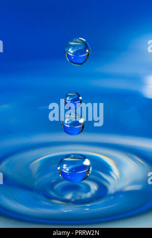 A drop of water create a stunning random water effect. Stock Photo