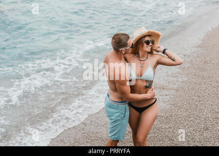 high angle view of happy young couple embracing on beach at montenegro Stock Photo