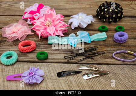 Different hair clips on wooden background Stock Photo