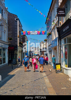 12 June 2018: Falmouth, Cornwall, UK - People shopping in Church Street on a beautiful sunny summer day. Stock Photo