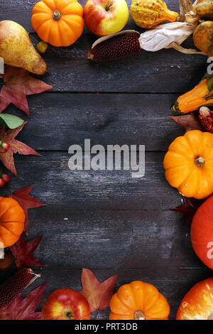 Autumn nature concept. Fall fruit and vegetables on wood. Thanksgiving dinner. Pears and pumpkin with sunflowers and apples Stock Photo