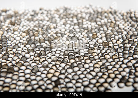 Macro of silica gel balls laying on white background.Its use to prevent mold, mildew, corrosion, odours and other moisture damage Stock Photo