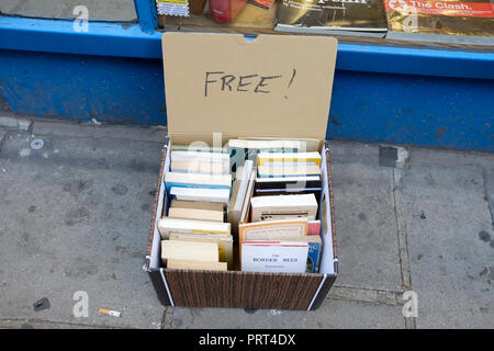 A box of free books left outside a second hand book shop in central London. Stock Photo
