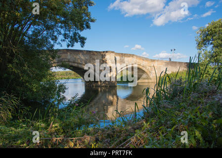 Old single track stone road bridge over the River Derwent between Elvington and Sutton in Yorkshire Stock Photo