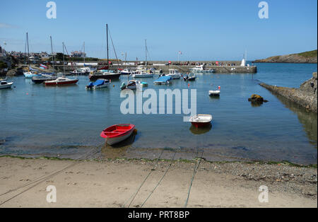 Moored up Fishing Boats at the Harbour in Village of Cemaes on the Isle of Anglesey Coastal Path, Wales, UK. Stock Photo