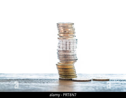 stack of euro coins on table against white background Stock Photo