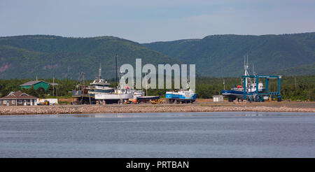 CHETICAMP, NOVA SCOTIA, CANADA - Fishing boats in drydock on beach, Cape Breton Island. Stock Photo