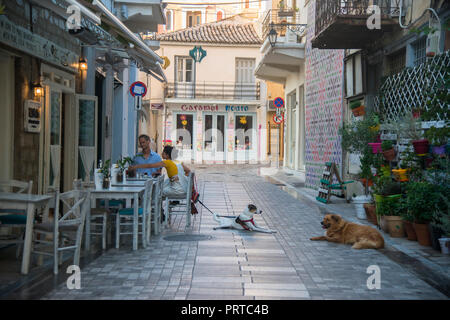 Young couple having breakfast with their dog at a restaurant Stock Photo
