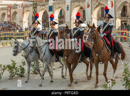 row of four carabinieri in high uniform on horseback Stock Photo