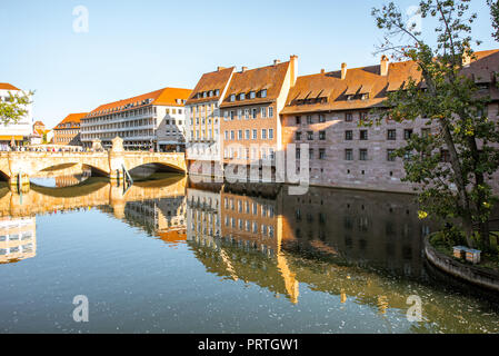 Morning view on the riverside with beautiful old buildings and bridge in Nurnberg city, Germany Stock Photo