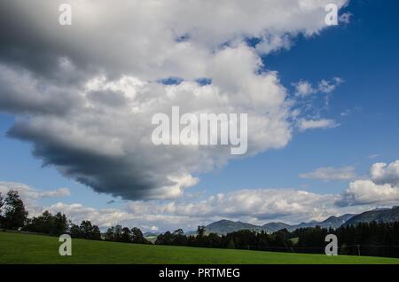 Clouds over the Bavarian Alps - Clouds are given different names based on their shape and their height in the sky. Stock Photo