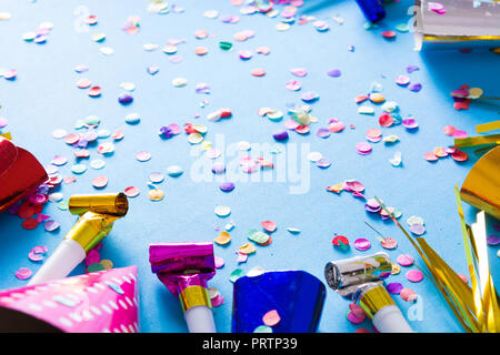 Party background. Party caps and confetti on blue background. Copyspace Stock Photo