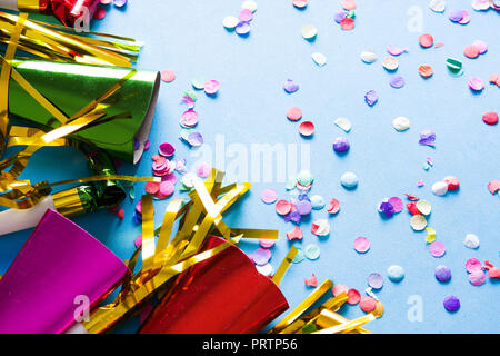 Party background. Party caps and confetti on blue background. Copyspace Stock Photo