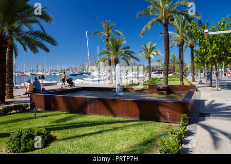 ALCUDIA, MAJORCA, SPAIN - September 23rd, 2018: Promanade along marina.  Port d'Alcudia  is a popular resort town and holiday destination on the north Stock Photo