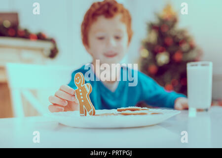 Focused photo on male hand that holding biscuit Stock Photo