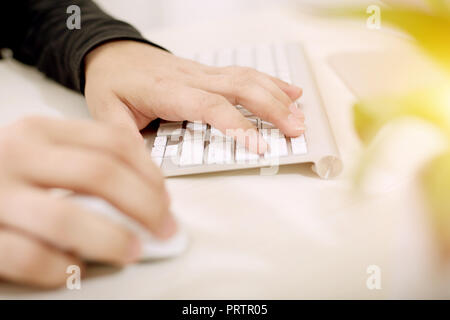 Both hands on keyboard and mouse. Stock Photo
