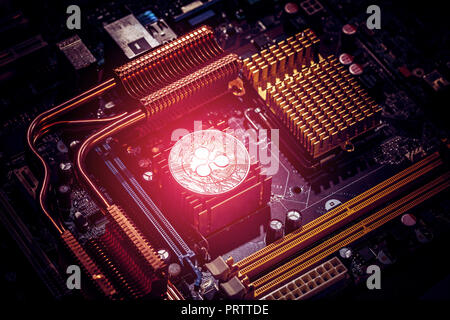 Ripple coin on a computer motherboard. New independent worldwide cryptocurrency Stock Photo
