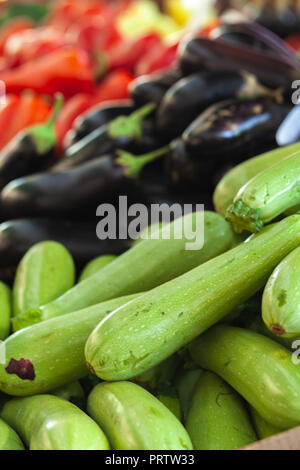 Pile of fresh vegetables laying on a marketplace counter Stock Photo