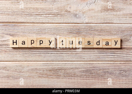 Happy Tuesday word written on wood block. Happy Tuesday text on table, concept. Stock Photo