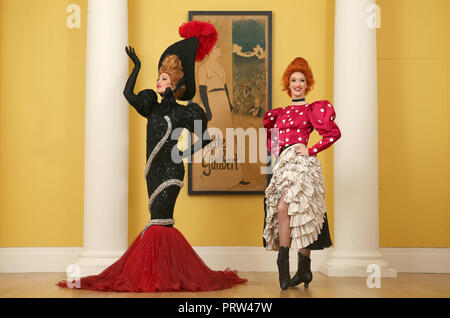 Mathilde Tutiaux (left) and Lucy Monaghan, can-can dancers from the Moulin Rouge in Paris, perform alongside a lithograph poster for Yvette Guilbert (1894) at opening of the new exhibition 'Pin-Ups: Toulouse-Lautrec and the Art of Celebrity' at the Royal Scottish Academy in Edinburgh. Stock Photo
