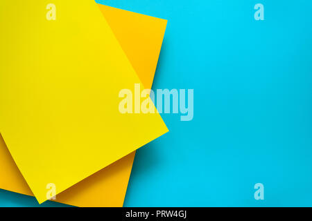 Blue and yellow pastel color papered background. Volume geometric flat lay. Top view. Copy space Stock Photo