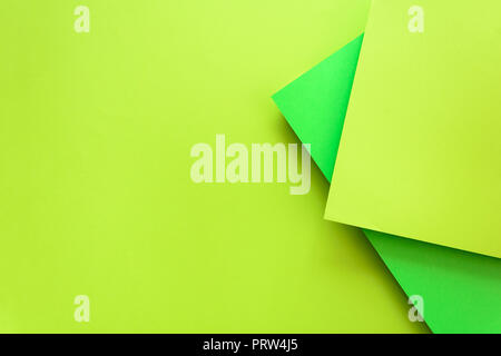 Green and lime pastel color papered background. Volume geometric flat lay. Top view. Copy space Stock Photo