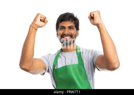 Happy supermarket or hypermarket indian employee celebrating with arms up isolated on white background Stock Photo