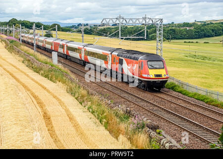 LNER high speed train still in Virgin colours at Park Farm near Linlithgow West Lothian Scotland UK travelling from Inverness to London via Edinburgh Stock Photo