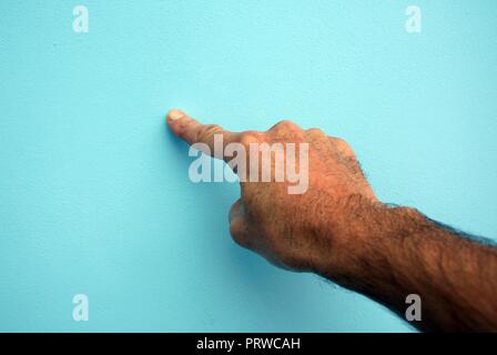 Mans hand pushing an imaginary button Stock Photo
