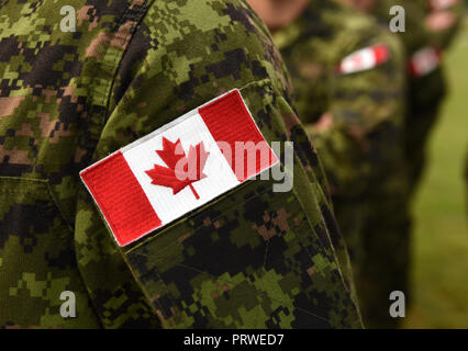 Canada patch flag on soldiers arm. Canadian troops Stock Photo