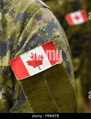Canada patch flag on soldiers arm Stock Photo