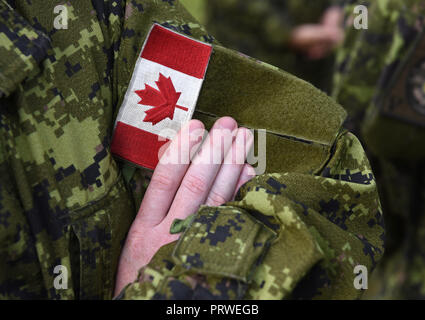 Canada patch flag on soldiers arm Stock Photo