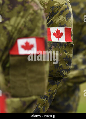 Canada patch flags on soldiers arm. Canadian troops Stock Photo