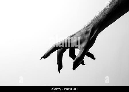 Black creepy halloween monster hand with long nails Stock Photo