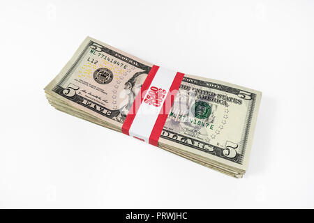 Pack of five dollar bills with $500 paper currency strap. Stock Photo