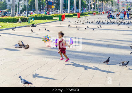 Phnom Penh, Cambodia - April 9, 2018: Preah Sisowath Quay, a riverside public promenade on the bank of the Tonle Sap River with its  large, long open  Stock Photo