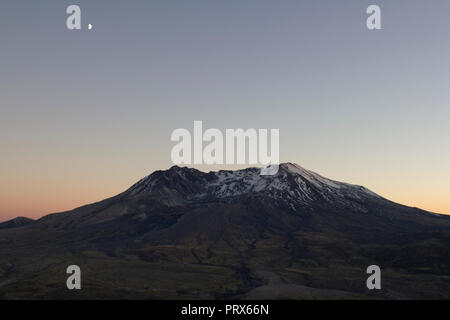 Moon over Mount St Helens during sunset. Stock Photo