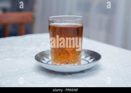 Azerbaijan tea in traditional glass on tray closeup Stock Photo