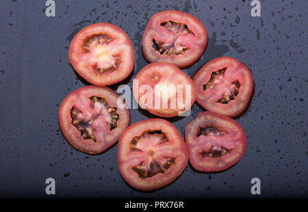 The sliced tomato isolated on dark background   at  mumbai Maharashtra india Stock Photo